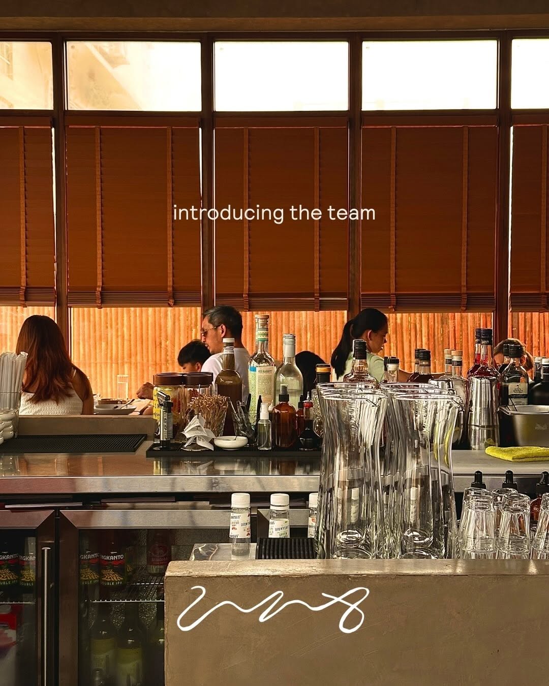 UNA bar interior with bamboo blinds and team